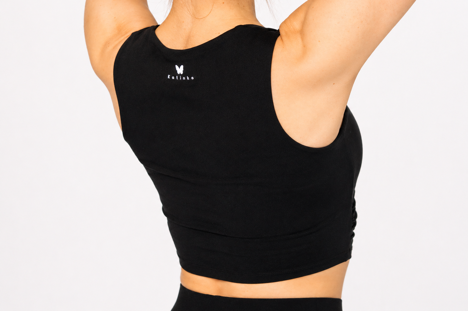 Black sports bra with a visible brand logo on a plain background