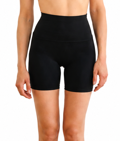 Woman wearing a black athletic outfit on a white background