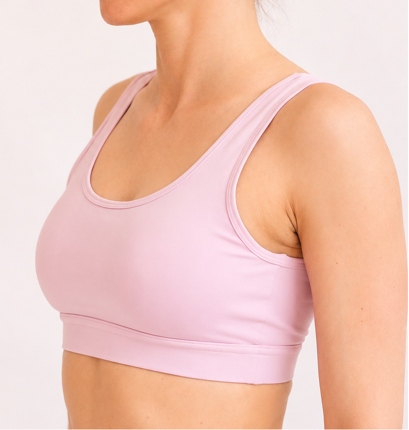 Light pink sports bra on a plain background