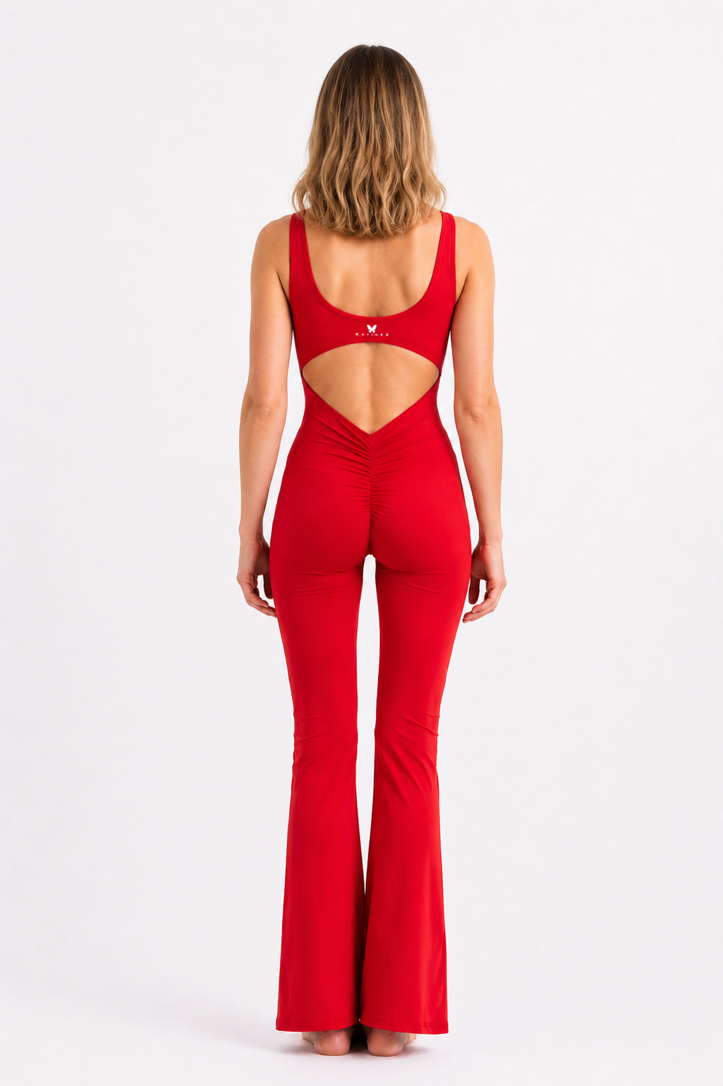 Red jumpsuit with cut-out design on a white background